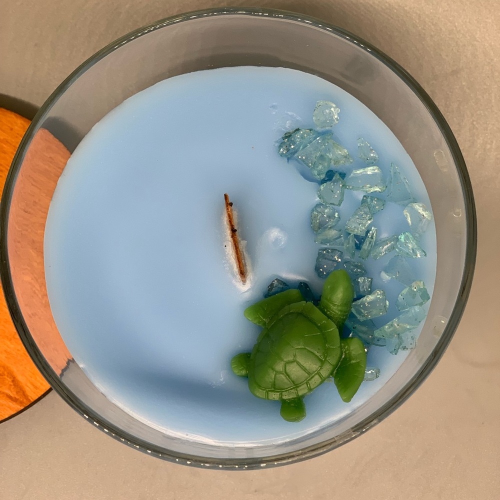 12 0z. Blue candle with wax turtle